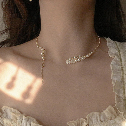 Elegant handcrafted clavicle necklace made of natural pearl shell with an intricate floral pattern, a timeless British design accessory.