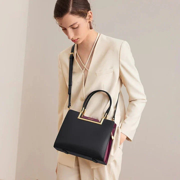 Elegant premium genuine leather tote bag with spacious interior, multiple compartments, and a secure zipper closure for everyday use