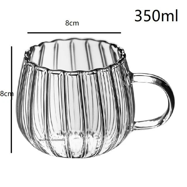 A set of heat-resistant glass mugs featuring a charming pumpkin pattern design, perfect for cosy UK mornings.
