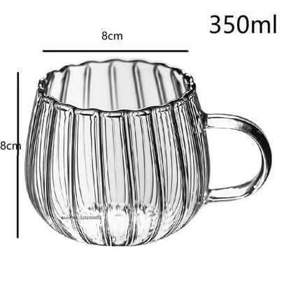 A set of heat-resistant glass mugs featuring a charming pumpkin pattern design, perfect for cosy UK mornings.