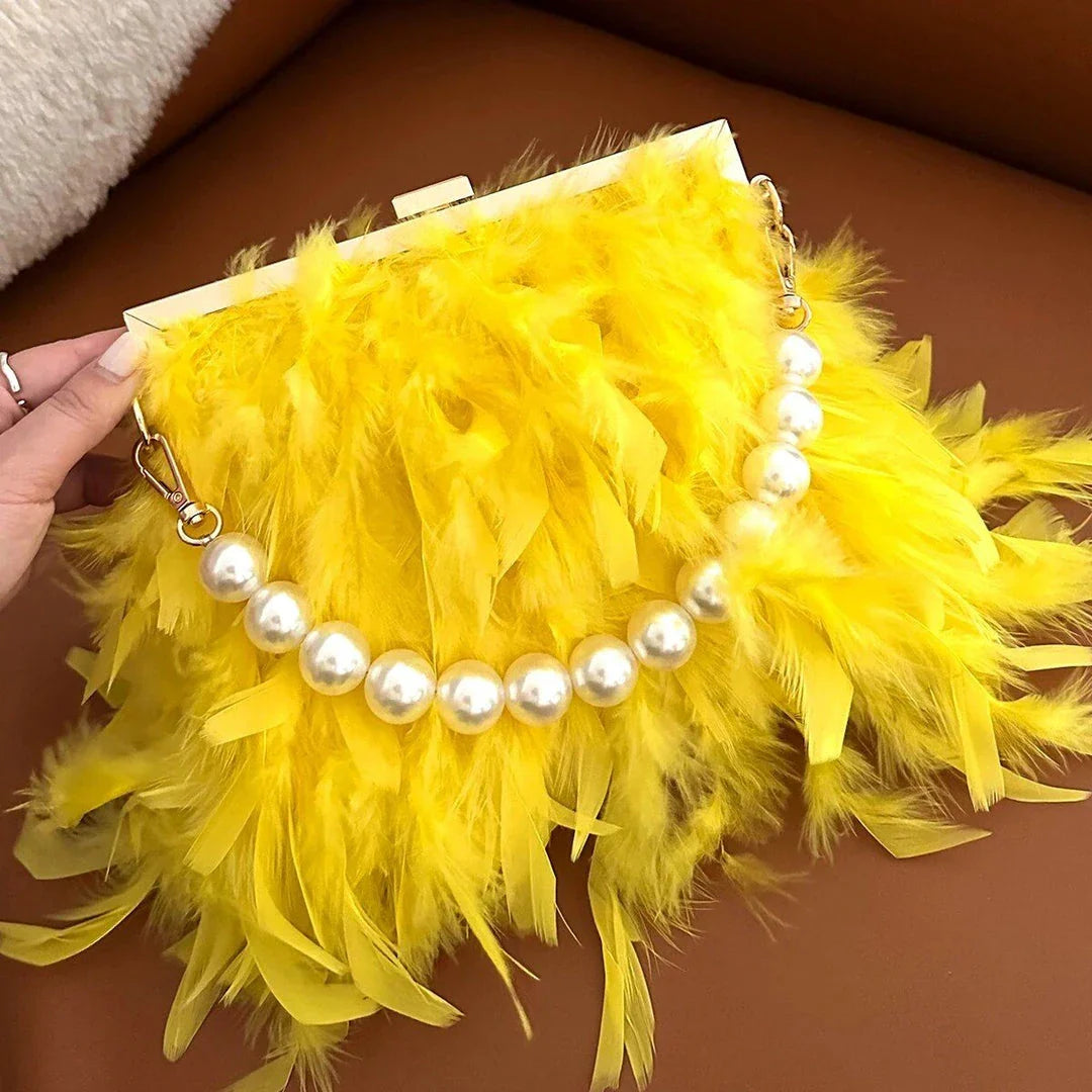 Elegant feather clutch bag with pearls and metal chains, a versatile and sophisticated evening accessory
