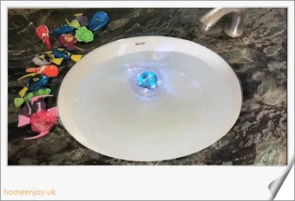 Electric robotic fish swimming in a fishbowl, mimicking the natural movements of a real fish