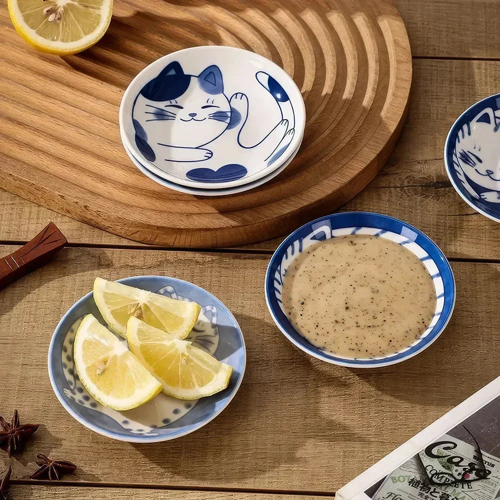 Charming Japanese ceramic sauce dish with a lucky cat design, perfect for serving sauces, sushi, and more.