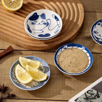 Charming Japanese ceramic sauce dish with a lucky cat design, perfect for serving sauces, sushi, and more.