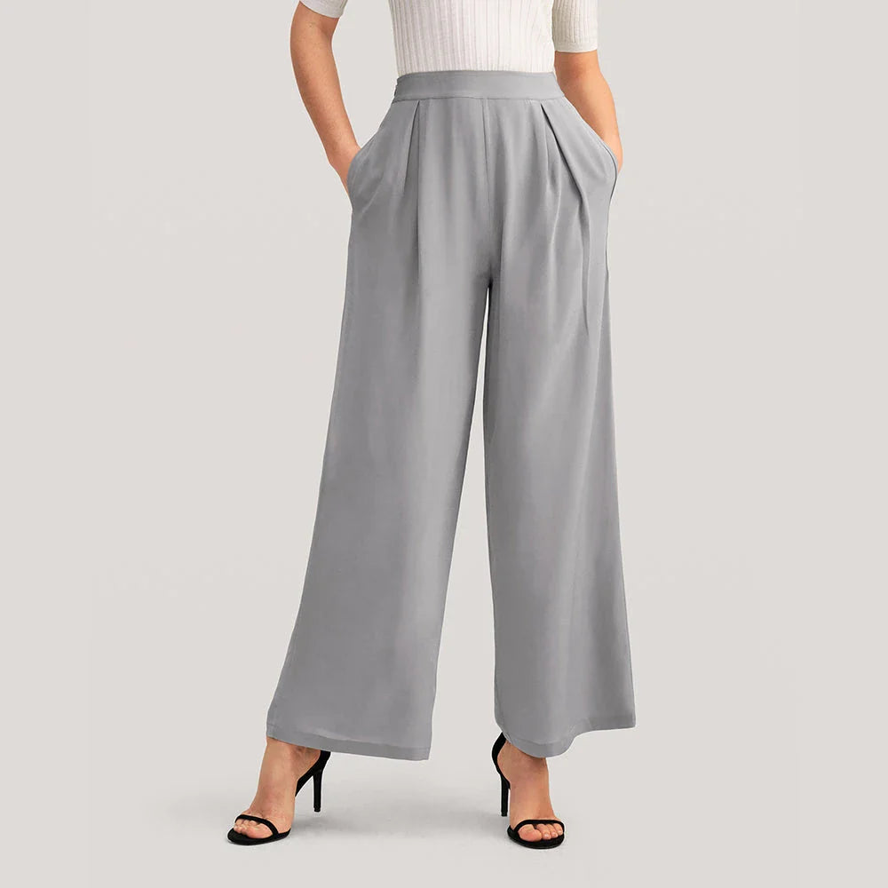 Chic silk wide-leg trousers in a sophisticated grey colour, featuring a high-waist design and relaxed fit for all-day comfort and style.