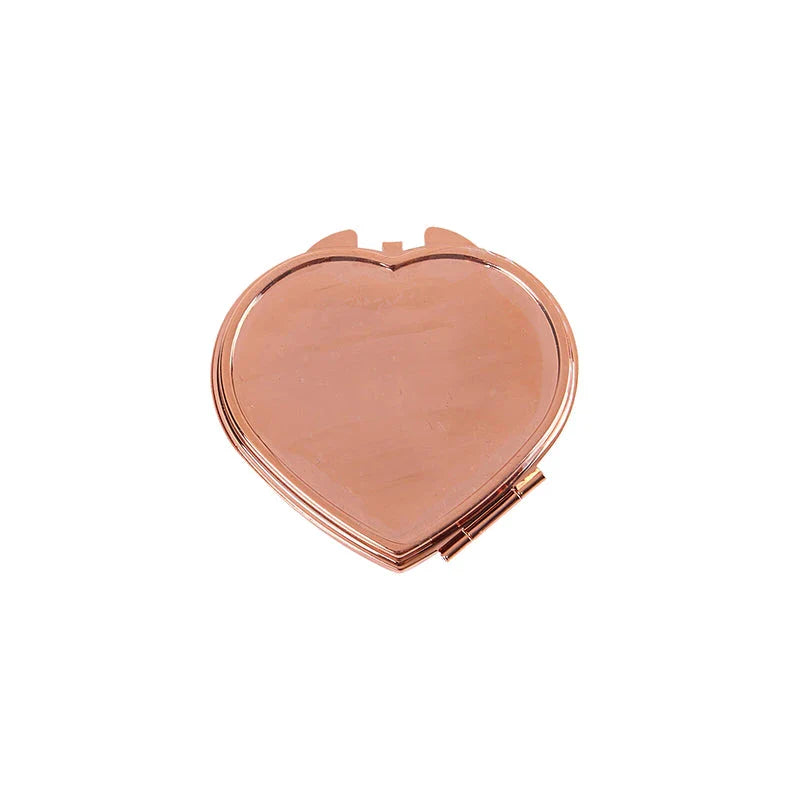 Heart-shaped metal pill box with built-in mirror for convenient storage and touch-ups on the go