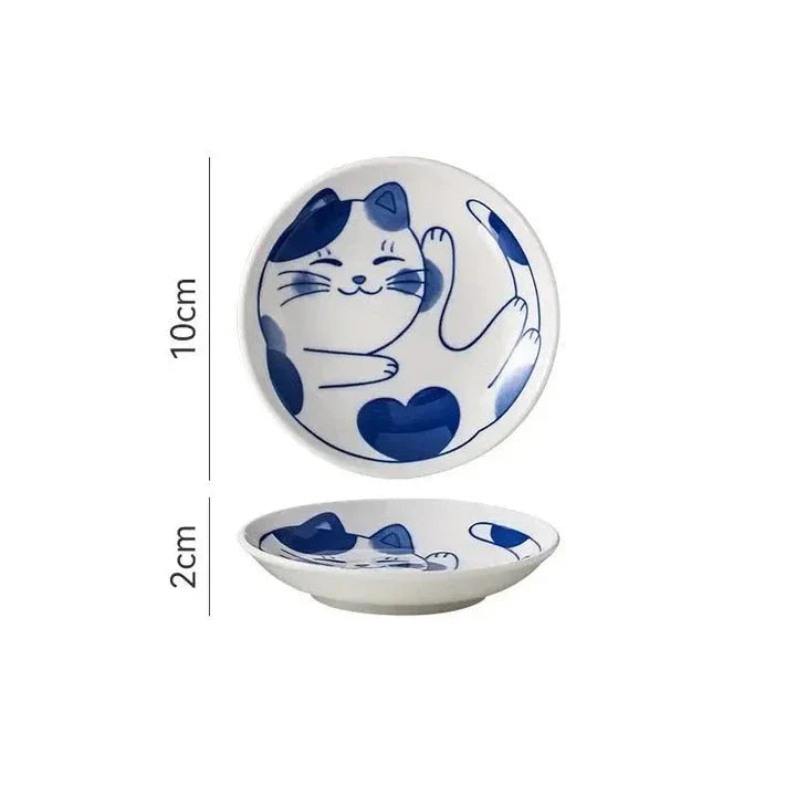 Charming Japanese ceramic sauce dish with a lucky cat design, perfect for serving sauces, sushi, and more.