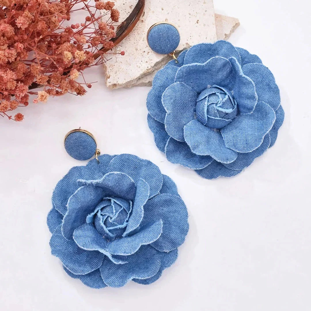 Elegant denim drop earrings with intricate details, a versatile accessory that adds a touch of refined British style to any outfit.