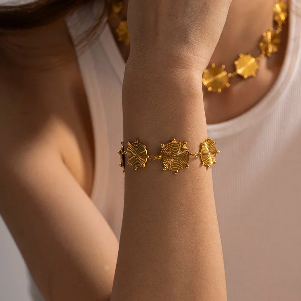 Close-up of a luxurious 18K gold plated stainless steel bracelet with an elegant palace-style design