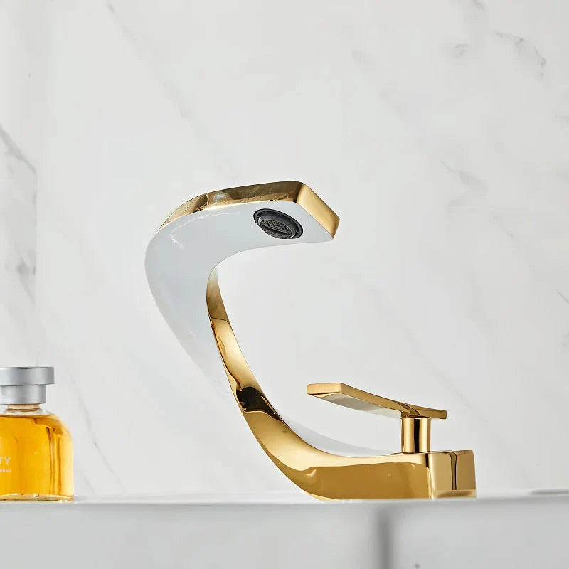 Elegant brass gold and white bathroom basin faucet with sleek, contemporary design