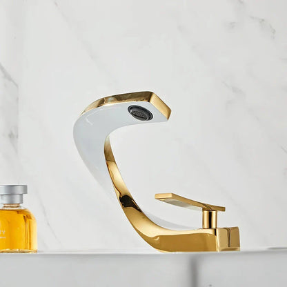 Elegant brass gold and white bathroom basin faucet with sleek, contemporary design