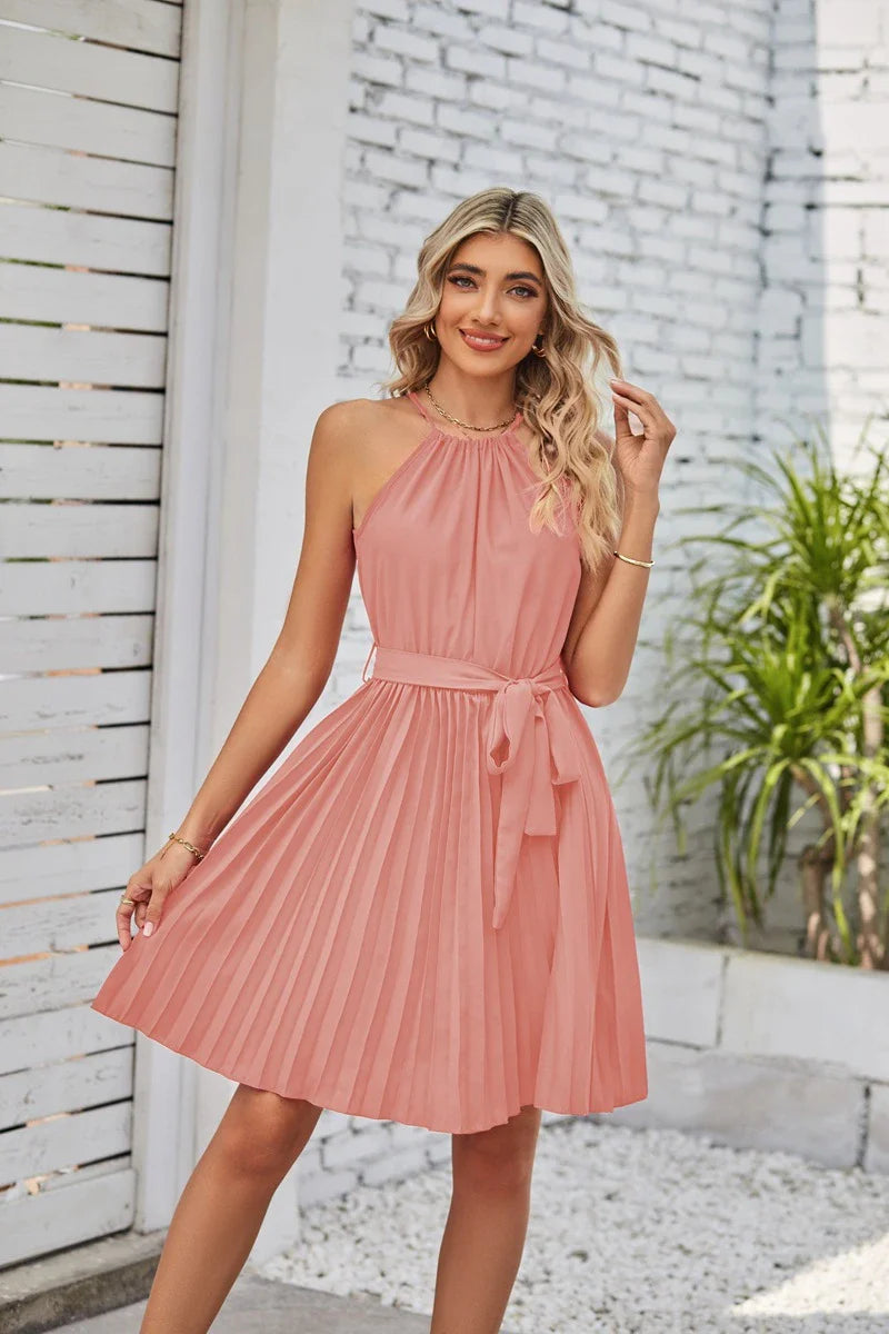 Elegant halter sundress in a variety of colours, featuring a pleated skirt and adjustable waistline for a customised fit