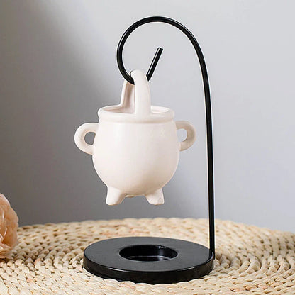Captivating iron frame essential oil diffuser and candle holder with a unique witch's soup cup design