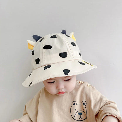 Adorable cow-patterned kids' bucket hat made of soft, breathable cotton for comfortable outdoor wear