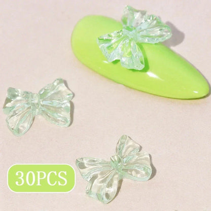 Charming candy-coloured bow nail charms in various colours, perfect for adding a playful touch to your manicure
