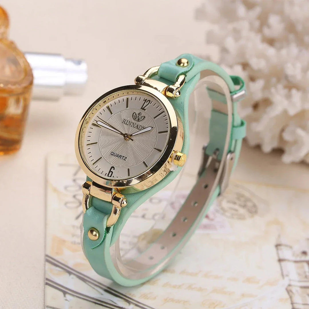 Elegant women's quartz watch with a black leather strap, featuring a sleek alloy case and a durable glass dial window