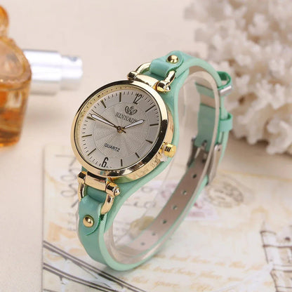 Elegant women's quartz watch with a black leather strap, featuring a sleek alloy case and a durable glass dial window