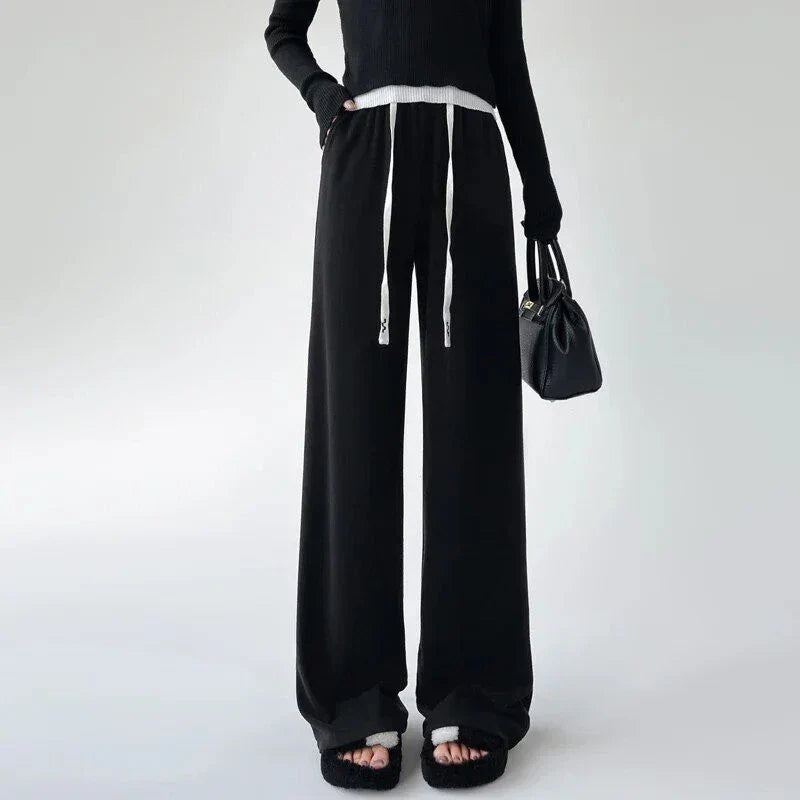 Elegant high-waist drawstring trousers in black, featuring a wide-leg cut and stylish lace-up pockets
