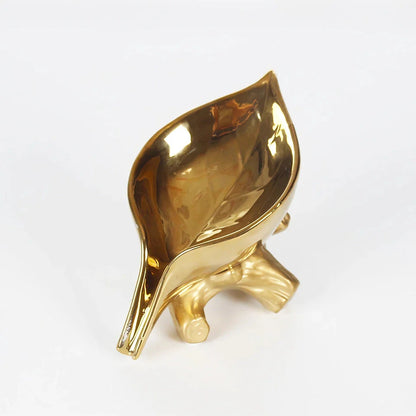 Elegant ceramic leaf-shaped soap holder with a sturdy base, adding a touch of nature-inspired sophistication to any bathroom