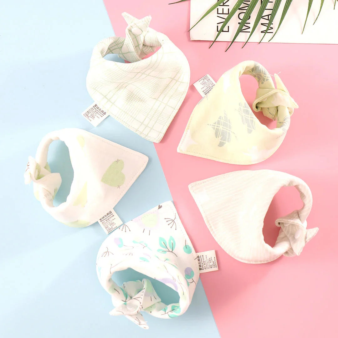A set of fashionable cotton baby bandana bibs in various prints and colours, designed to keep your little one dry and stylish.