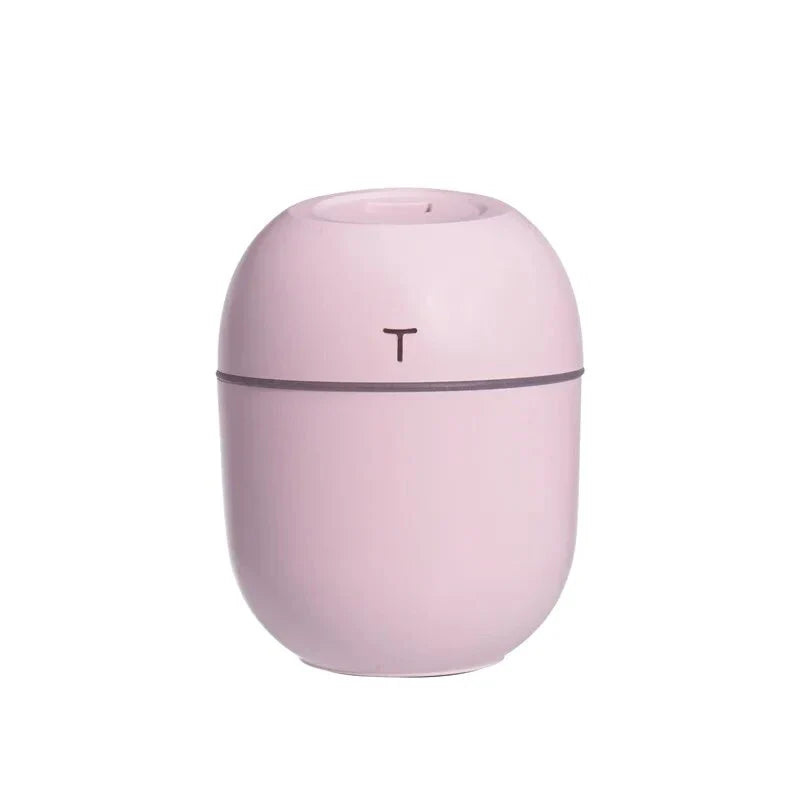 Compact ultrasonic humidifier and aroma diffuser with LED night lamp, featuring a 220 ml water tank and USB power supply
