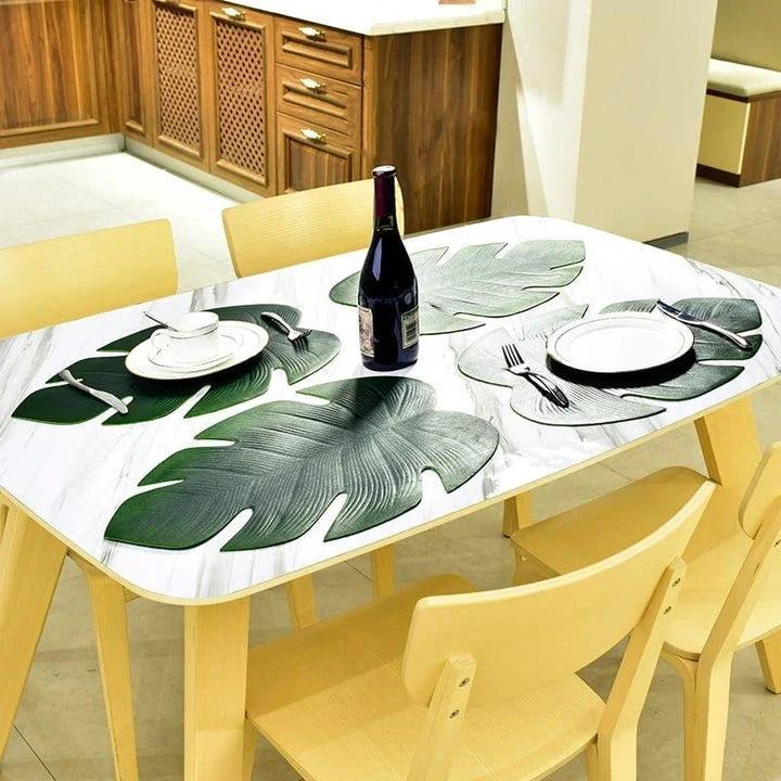 Elegant floral-patterned PVC dining table coaster in a contemporary setting, protecting a wooden table surface