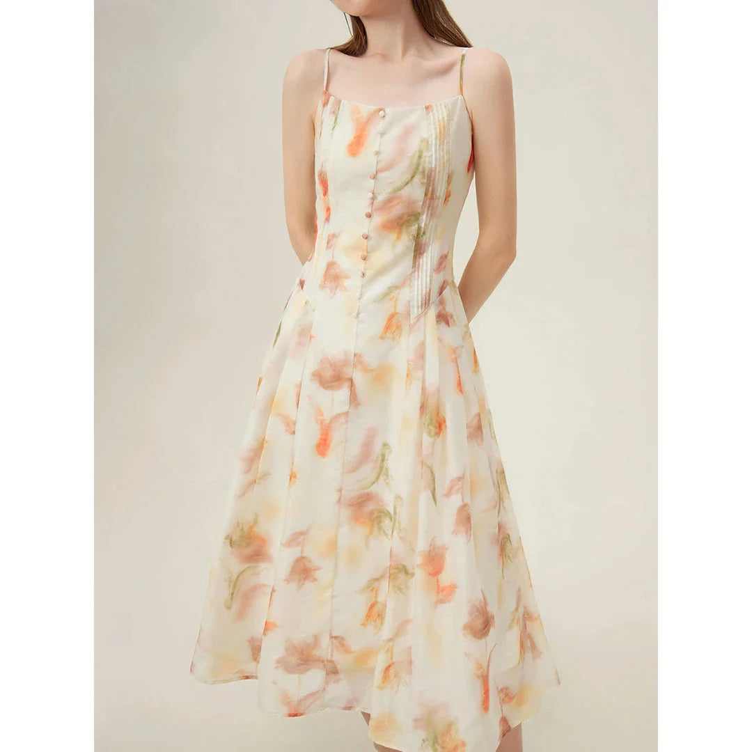 Elegant floral sleeveless summer dress in orange with a flattering A-line silhouette, perfect for British summer occasions.