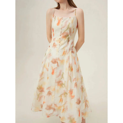 Elegant floral sleeveless summer dress in orange with a flattering A-line silhouette, perfect for British summer occasions.