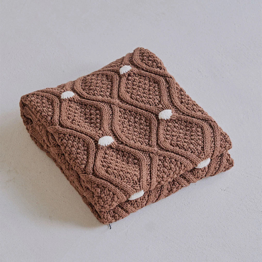 Cosy chunky knit blanket with charming pompoms in multiple sizes and colours for elegant home décor