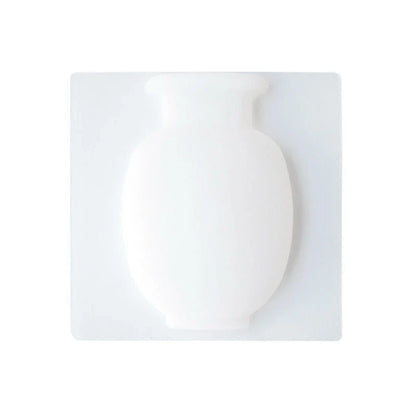 Elegant silicone suction wall vase in pink, designed to hold various plant sizes and fit seamlessly in modern homes