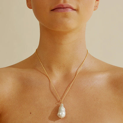 Elegant freshwater pearl necklace with a unique fish tail-shaped pendant and a delicate O-shaped chain