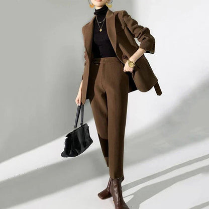 Elegant wool pant suits for women featuring a high-waist design, raglan sleeves, and modern 'hip hop' style trousers in a solid black colour