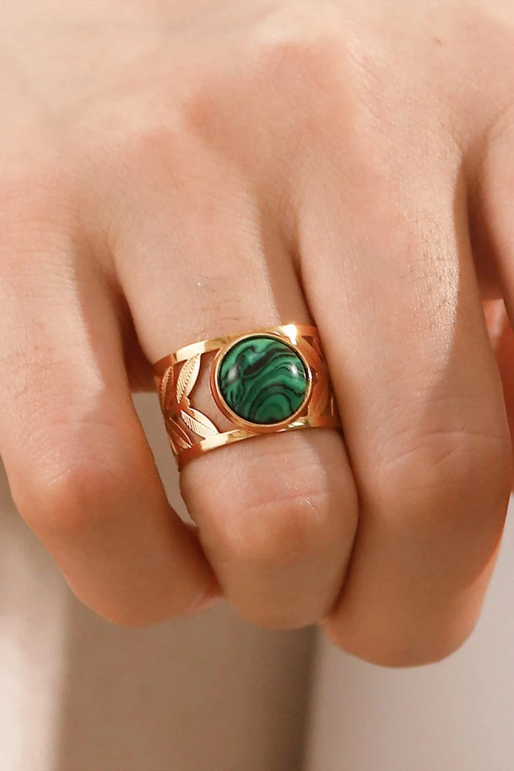Elegant 18K gold-plated malachite leaf ring in a flat lay, studio style photograph