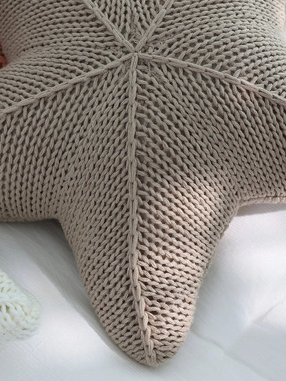 Artfully hand-knitted starfish-shaped cushion in a range of sophisticated colour options, providing plush comfort and coastal charm for any living space.