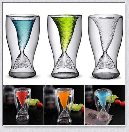 A transparent glass mug with a decorative mermaid tail design, perfect for enjoying a range of beverages in style.
