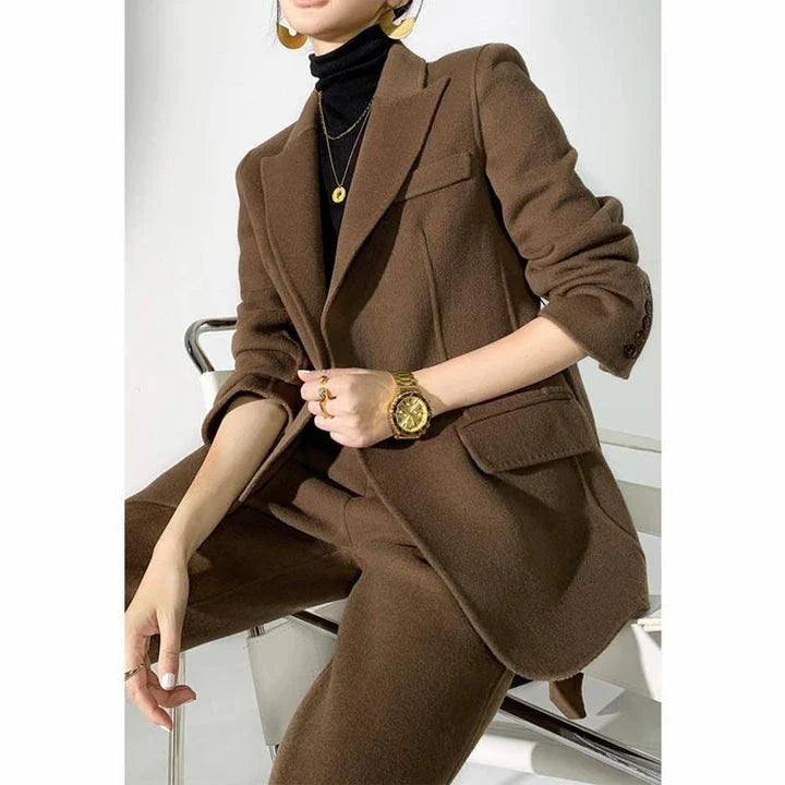 Elegant wool pant suits for women featuring a high-waist design, raglan sleeves, and modern 'hip hop' style trousers in a solid black colour