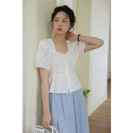 Elegant vintage white blouse with square neckline, puff sleeves, and lace-up detail