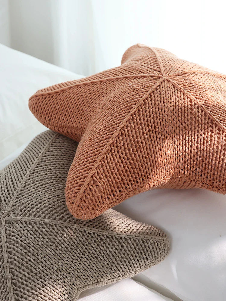 Artfully hand-knitted starfish-shaped cushion in a range of sophisticated colour options, providing plush comfort and coastal charm for any living space.