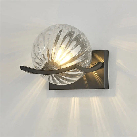 Modern black iron wall lamp with clear glass shade and LED lighting for a sophisticated look