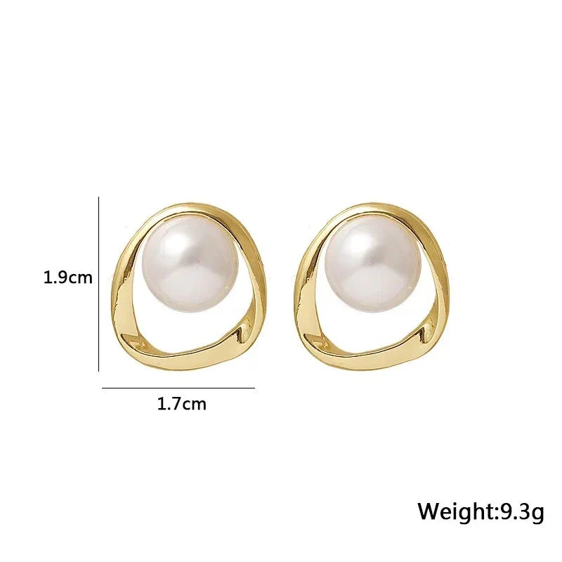 Elegant gold-coloured simulated pearl stud earrings with a distinctive geometric design