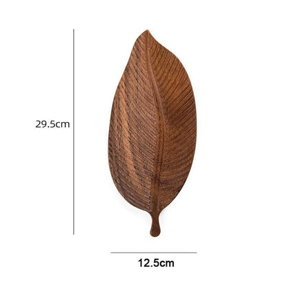 Elegant leaf-shaped serving platter made of solid oak wood, featuring a natural and stylish design for hosting and entertaining