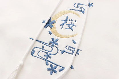 A cosy, velvet-padded hooded sweater with playful alphabet sleeves in pink and blue colours