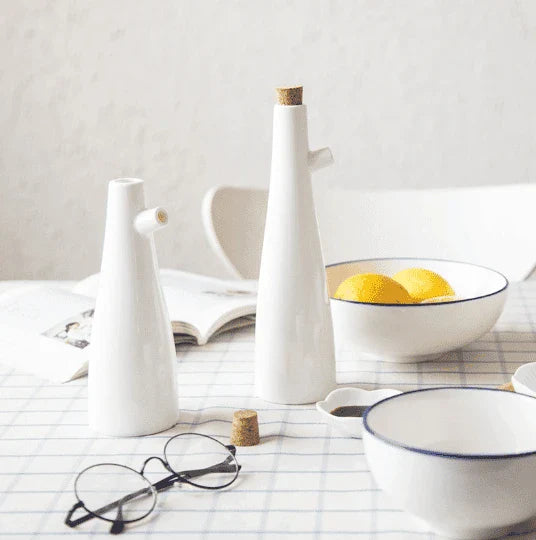 Elegant white porcelain storage bottles with Mediterranean-inspired design for kitchen organisation and decor