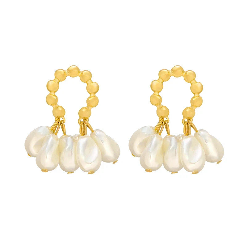 Pair of elegant Baroque-inspired pearl earrings with a silver and gold plated alloy setting