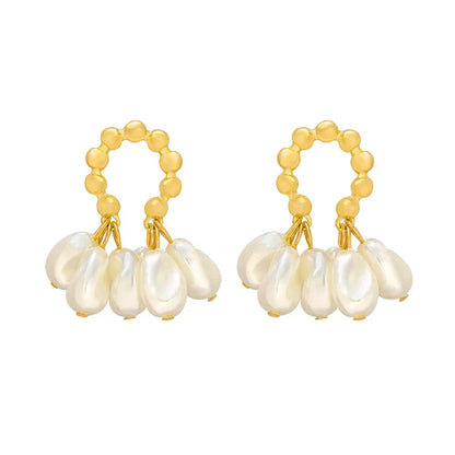 Pair of elegant Baroque-inspired pearl earrings with a silver and gold plated alloy setting