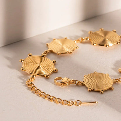 Close-up of a luxurious 18K gold plated stainless steel bracelet with an elegant palace-style design