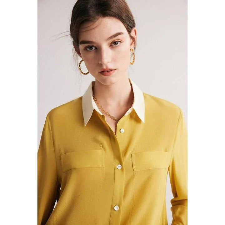 A chic and elegant silk crepe de chine blouse in a timeless solid pattern, perfect for professional and casual wear.