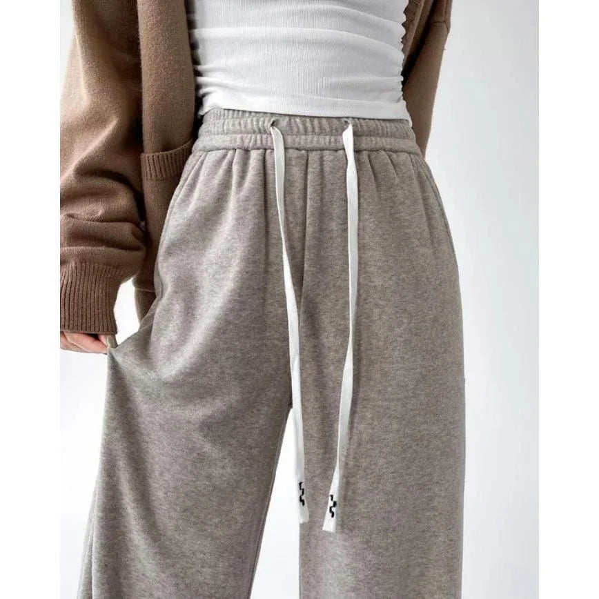 Elegant high-waist drawstring trousers in black, featuring a wide-leg cut and stylish lace-up pockets