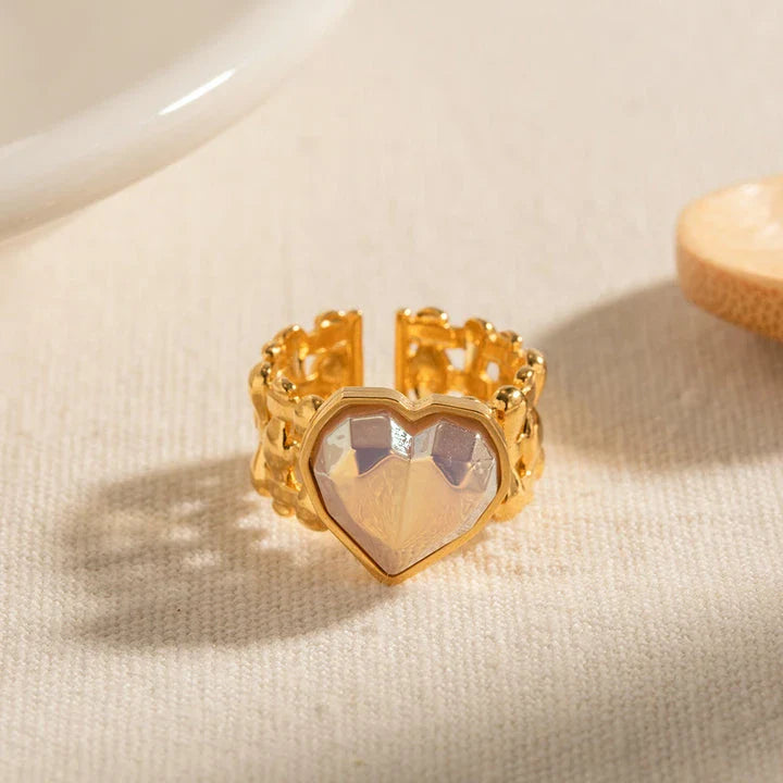 Adjustable stainless steel ring with a mermaid-inspired heart design and shell beads, a unique and versatile accessory.