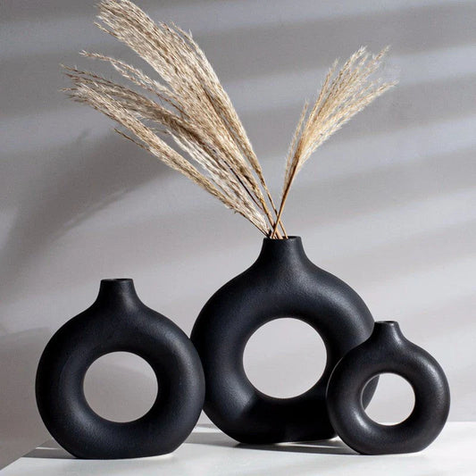Circular hollow ceramic vase with minimalist design, perfect for displaying dried flowers or as a standalone decor piece